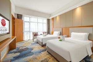 Postel nebo postele na pokoji v ubytování Zhangzhou Yuyuan Hotel