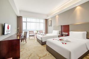 Postel nebo postele na pokoji v ubytování Zhangzhou Yuyuan Hotel