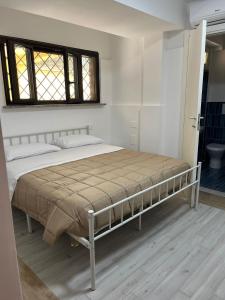 a large bed in a bedroom with a window at Aurora Rooms in Pomigliano dʼArco