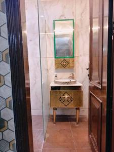 a bathroom with a sink and a mirror at HostMyStay-3BHk ! Gk1 - RBlck! in New Delhi +22 photos