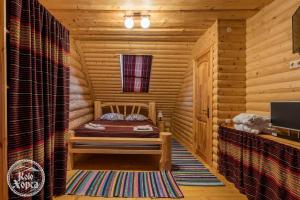 een kamer met een bed in een blokhut bij Коло Хорса in Slavske +46 foto's
