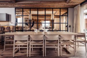 a dining room with a large wooden table and chairs at Antarès SIRIUS 201 - Prestigious ski inski out apartment in Méribel