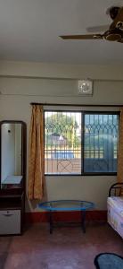 a room with a table in front of a window at Lama Residence in Siliguri