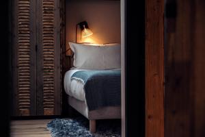 a bedroom with a bed and a chair and a lamp at Antarès SIRIUS 301- Spacious ski inski out apartment in Méribel