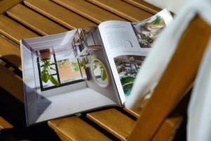 an open book on a bench with a window at Villa Viviana - by MyHomeInComo in Menaggio +71 photos