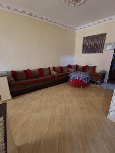 a living room with a couch and a table at ras el ma in Chefchaouene