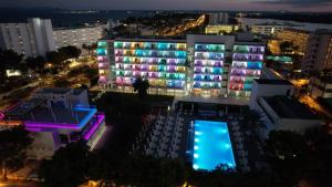 a large building with lit up windows at night at Hotel Astoria Playa Adults Only 4* Sup in Port d'Alcudia