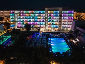 a building with a pool in front of it at night at Hotel Astoria Playa Adults Only 4* Sup in Port d'Alcudia