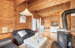 a living room with a couch and a fireplace in a log cabin at Ferienhaus Neckar 54 in Hayingen