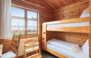 a bedroom with two bunk beds and a window at Ferienhaus Neckar 54 in Hayingen