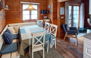 a kitchen and dining room with a table and chairs at Ferienhaus Neckar 71 in Hayingen
