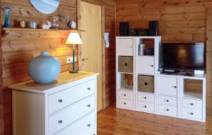 a room with a white dresser with a vase on top of it at Ferienhaus Neckar 71 in Hayingen