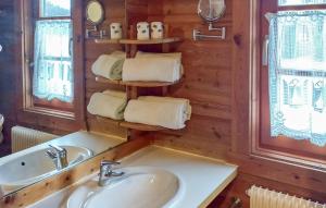 a bathroom with a sink and a mirror and towels at Ferienhaus Neckar 71 in Hayingen +9 photos