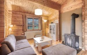a living room with a couch and a stove at Ferienhaus Neckar 68 in Hayingen