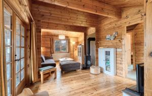 a log cabin living room with a couch and a table at Ferienhaus Neckar 68 in Hayingen