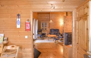 a log cabin with a room with chairs and a table at Ferienhaus Tauber 60 in Hayingen
