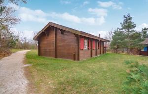 a small building with red doors on a grass field at Ferienhaus Tauber 60 in Hayingen