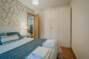 a bedroom with a bed with towels on it at Rodrigo in Palencia