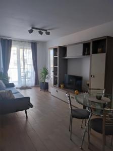 a living room with a couch and a table at grand hill panorama in Cluj-Napoca