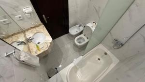 a bathroom with a sink and a toilet and a mirror at Sharah Mountains Hotel in Wadi Musa