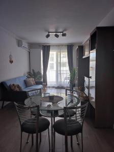 a living room with a glass table and chairs at grand hill panorama in Cluj-Napoca