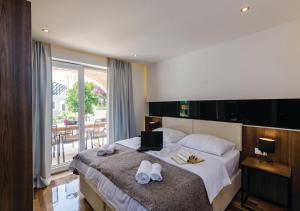 a bedroom with a bed with a laptop on it at Villa Stone Bliss with private Pool, near Dubrovnik in Zaton