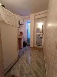 an empty room with a door to a kitchen at dar el fkih in Chefchaouene +5 photos