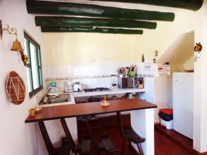 a kitchen with a wooden counter and a sink at Cabaña la Cattleya de Villa de Leyva in Villa de Leyva