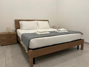 a bedroom with a bed with two towels on it at Floriana Cosy Corner in Il-Furjana