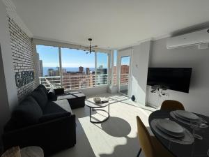a living room with a couch and a large window at El Apartamento de Cristian 4 in Benidorm