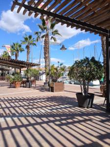 a pavilion with palm trees and plants on a beach at Casa Bella Vista in Alhama de Murcia
