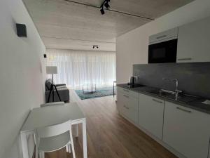 a kitchen with a sink and a counter top at City Hotel und City Apartments Centrum in Kaiserslautern