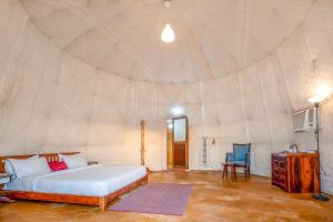 a bedroom with a bed in a tent at Surya-Ansh Desert Wellness Resort in Chhilro
