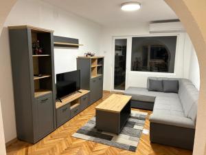 a living room with a couch and a tv at Mila apartments in Prilep