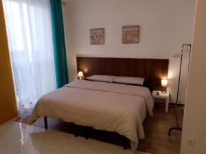 Posteľ alebo postele v izbe v ubytovaní L'Arco