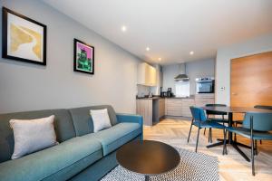 a living room with a couch and a table at Staycity Aparthotels Edinburgh West End in Edinburgh