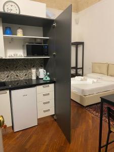 a kitchen and a bedroom with a bed in a room at Araba Fenice Apartments - Bari Centro in Bari