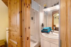 a bathroom with a sink and a shower and a tub at Ferienwohnungen Bunge in Krostitz +87 photos