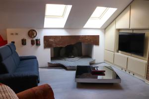 a living room with a fireplace and a blue couch at La Corte di Brusuglio Apartments in Cormano