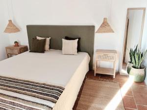 a bedroom with a large bed and a mirror at Monte de Santa Rita in Évora Monte