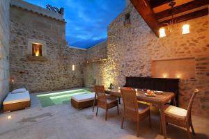 a patio with a table and chairs and a pool at Mallorca One in Pollença