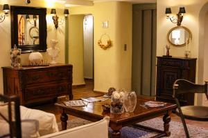 a living room with a table and a mirror at Hôtel La Villa Sainte Valérie Adults Only in Juan-les-Pins