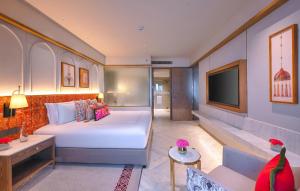 a hotel room with a bed and a tv at Taj Agra in Agra +29 photos