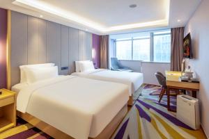 Postel nebo postele na pokoji v ubytování Lavande Hotel Beijing Tiananmen Square Wangfujing Street Branch