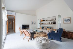 a living room with a couch and chairs and a table at Preciosa Villa ES TANCAT cerca de la playa es Trenc in Sa Ràpita