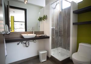 a bathroom with a toilet and a sink and a shower at Casa Q in Quito