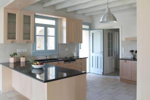 a kitchen with a large island in a room at Aetheras House in Galanádhon