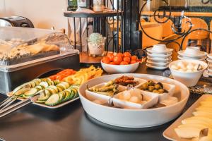 a buffet with different types of food on a table at Boutiquehotel Caravella Velden in Velden am Wörthersee +95 photos