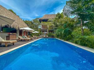 a swimming pool in front of a villa at Casa Origen Los Naranjos in Los Naranjos +93 photos