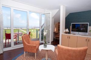 TV a/nebo společenská místnost v ubytování Janssens Hotel